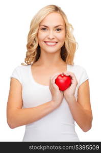shirt design, health, charity, love concept - smiling woman in blank white shirt with small red heart