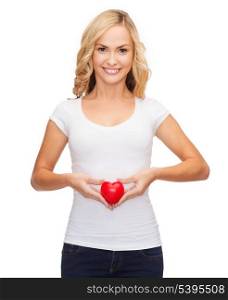shirt design, health, charity, pregnancy, digestion, love concept - smiling woman in blank white shirt with small red heart