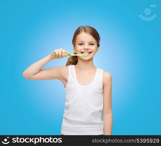 shirt design, health, oral hygiene, dental concept - smiling teenage girl in blank white shirt brushing her teeth