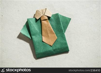 Shirt origami over white paper
