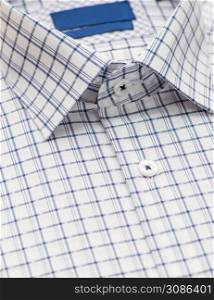 shirt with checkered pattern and with a focus on the collar and button, close-up. cotton shirt, close-up