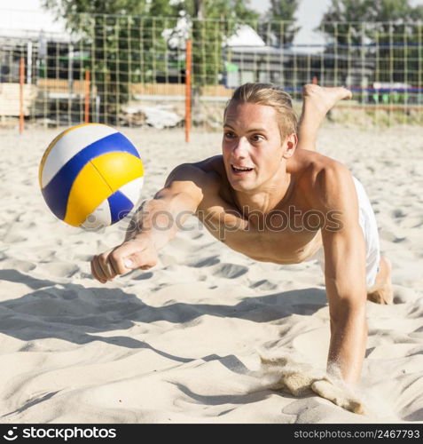 shirtless man playing volleyball beach