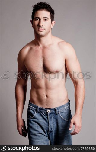Shirtless man walking in a grey isolated backround