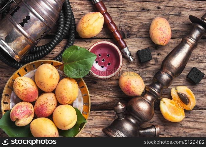Shisha hookah with apricot. Smoking hookah with tobacco with apricot flavor