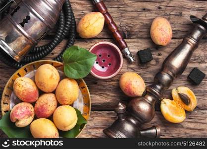 Shisha hookah with apricot. Smoking hookah with tobacco with apricot flavor
