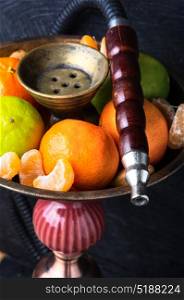 Shisha with taste of lime and tangerines. smoking hookah in Arabic style with a taste of lime and tangerines