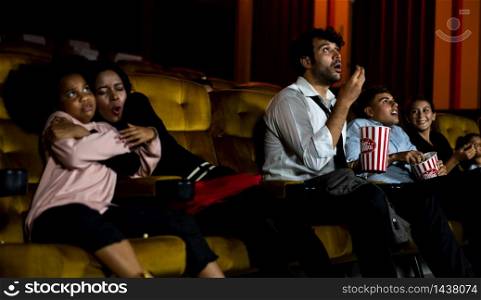 Shocked audience watching a horror movie in the cinema