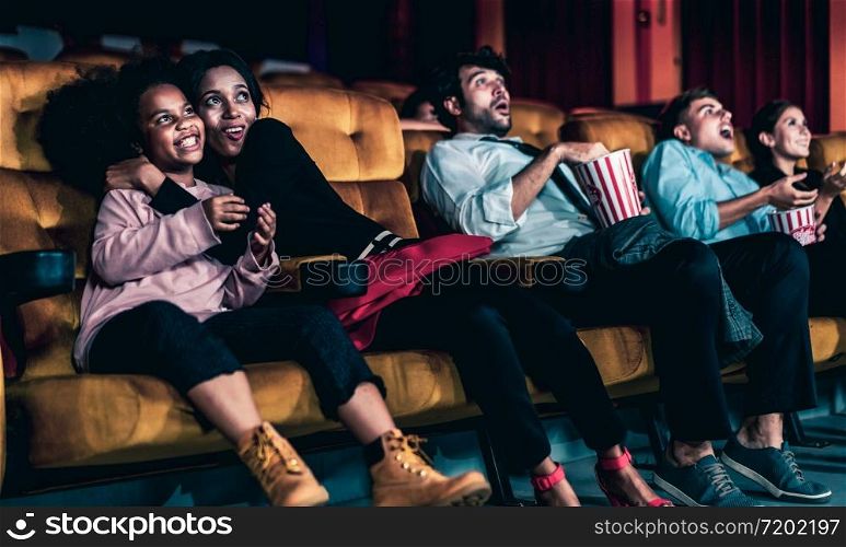 Shocked audience watching a horror movie in the cinema