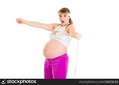 Shocked beautiful pregnant woman holding measure tape isolated on white&#xA;