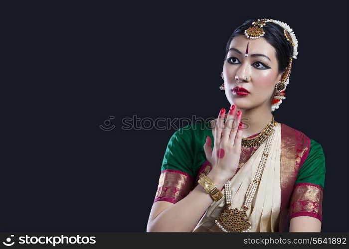 Shocked Bharatanatyam dancer over black background