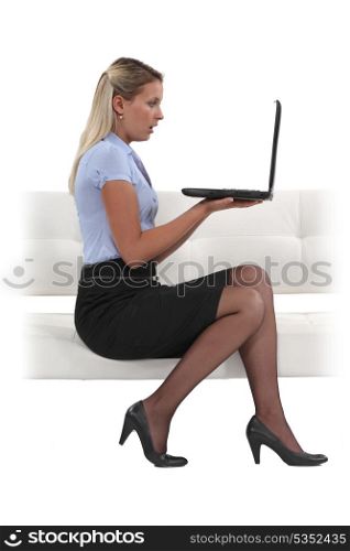 Shocked businesswoman reading an e-mail