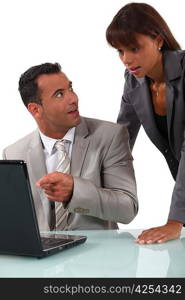 Shocked colleagues reading an e-mail message