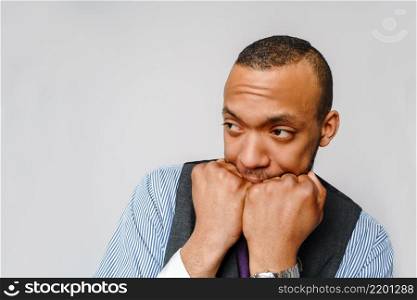 Shocked horrified african american man covering mouth with hands feel scared over grey background.. Shocked horrified african american man covering mouth with hands feel scared over grey background