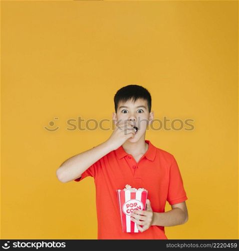 shocked kid eating popcorn