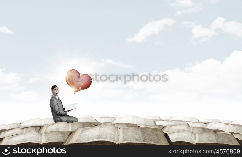 Shocked man with book. Young businessman with opened book in hands and love concept