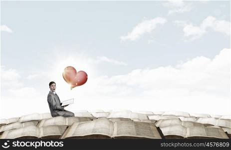 Shocked man with book. Young businessman with opened book in hands and love concept