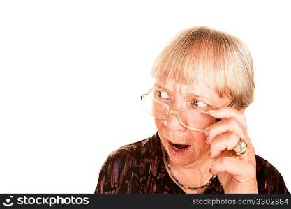 Shocked senior woman looking over the top of her glasses
