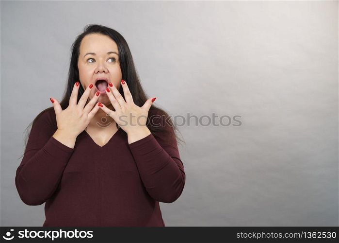 Shocked surprised mature adult woman gesturing with hands being terrified or scared.. Shocked terrified adult woman