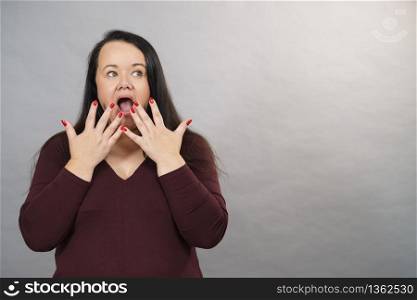 Shocked surprised mature adult woman gesturing with hands being terrified or scared.. Shocked terrified adult woman