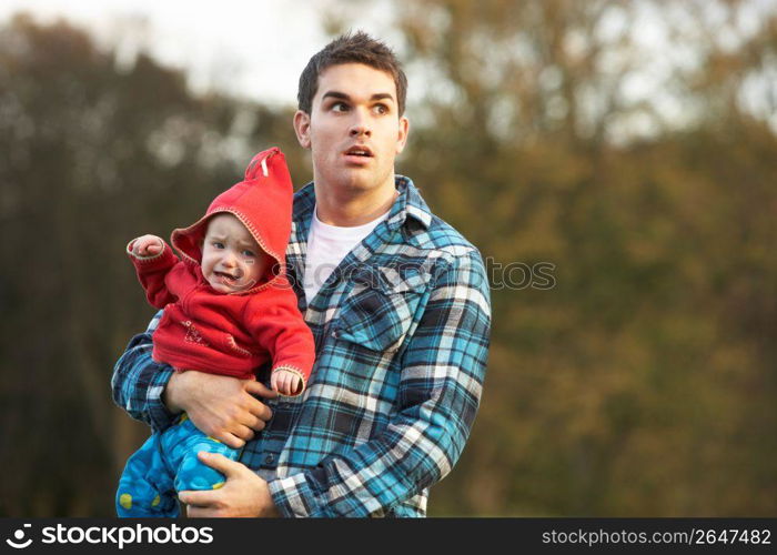 Shocked Teenage Boy Holding Baby