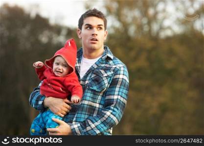 Shocked Teenage Boy Holding Baby