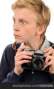Shocked teenage boy holding retro camera against white background