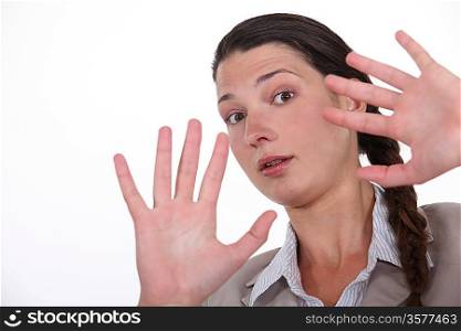 Shocked woman holding hands up