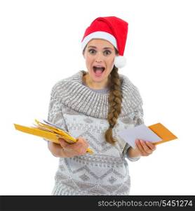 Shocked woman in Santa hat surprised by lots of Christmas letters