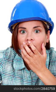 Shocked woman wearing a hard hat