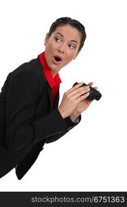 Shocked woman with a pair of binoculars