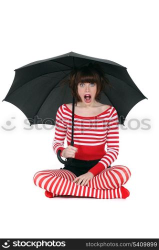 Shocked woman with umbrella