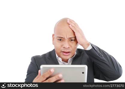 Shocked young business man with a tablet isolated on the white