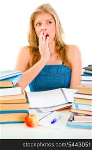 Shocked young girl sitting at desk with piles of books&#xA;