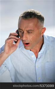 Shocker businessman talking on the phone