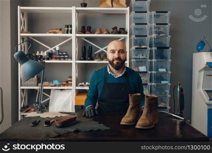 Shoemaker fix the shoe, footwear repair. Craftsman skill, shoemaking workshop, master works with boots, cobbler job. Shoemaker fix the shoe, footwear repair, cobbler