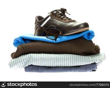 shoes and a mountain of clothes isolated on white