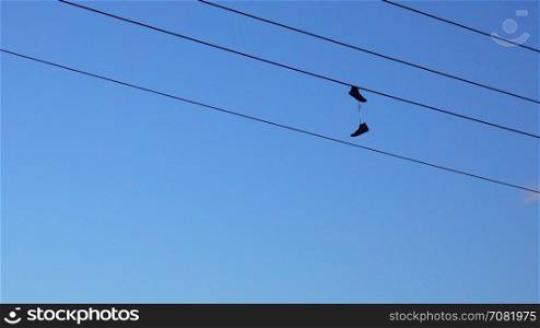 shoes haning on a power line