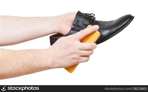 Shoeshiner brushing black shoe by brush isolated on white background