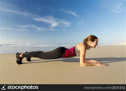 Shoot of a beautiful woman exercising herself in the beach