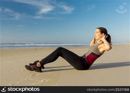 Shoot of a beautiful woman working her ABS in the beach