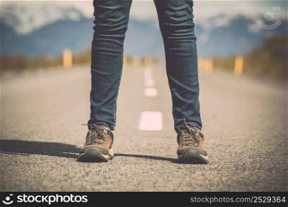 Shoot of a female legs in the center of a road
