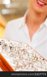 Shop assistant at the jeweler with jewellery