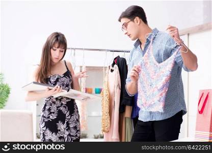Shop assistant helping woman with buying choice