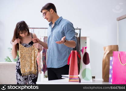 Shop assistant helping woman with buying choice