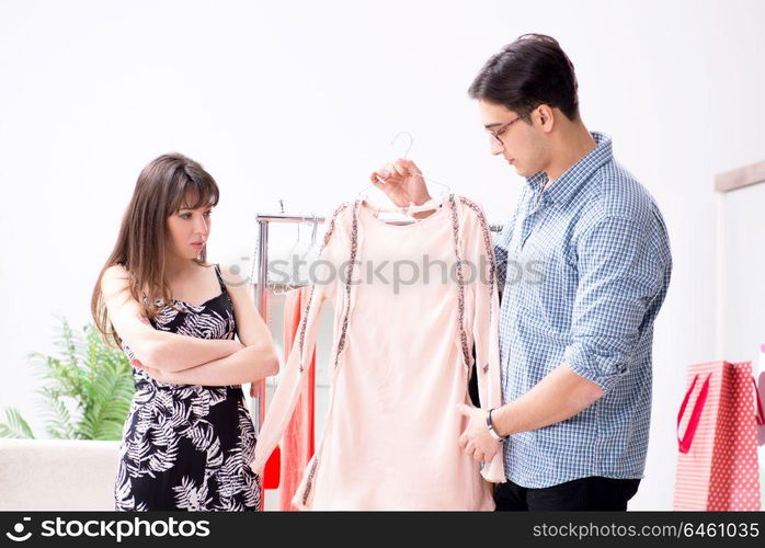 Shop assistant helping woman with buying choice