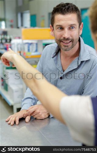 shop assistant pointing customer in right direction