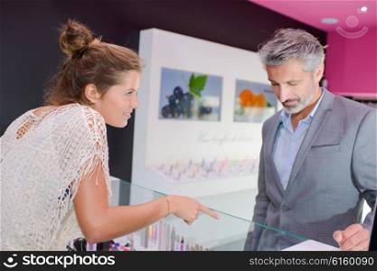 Shop assistant pointing to product
