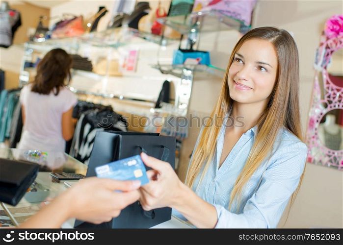Shop assistant taking a card payment