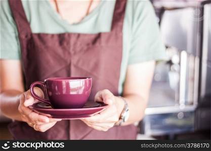 Shop owner serving freshly brewed coffee, stock photo