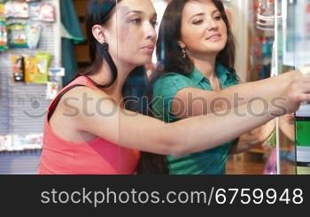 Shop representative offers goods to a buyer in the cosmetics department